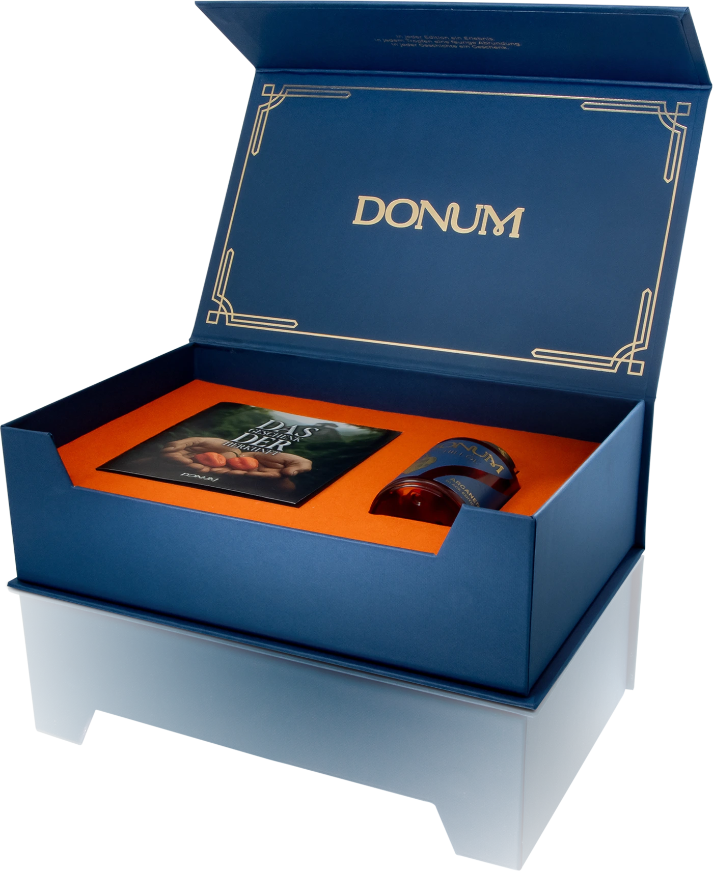 Geöffnete DONUM Geschenkbox mit Edition und Begleitheft